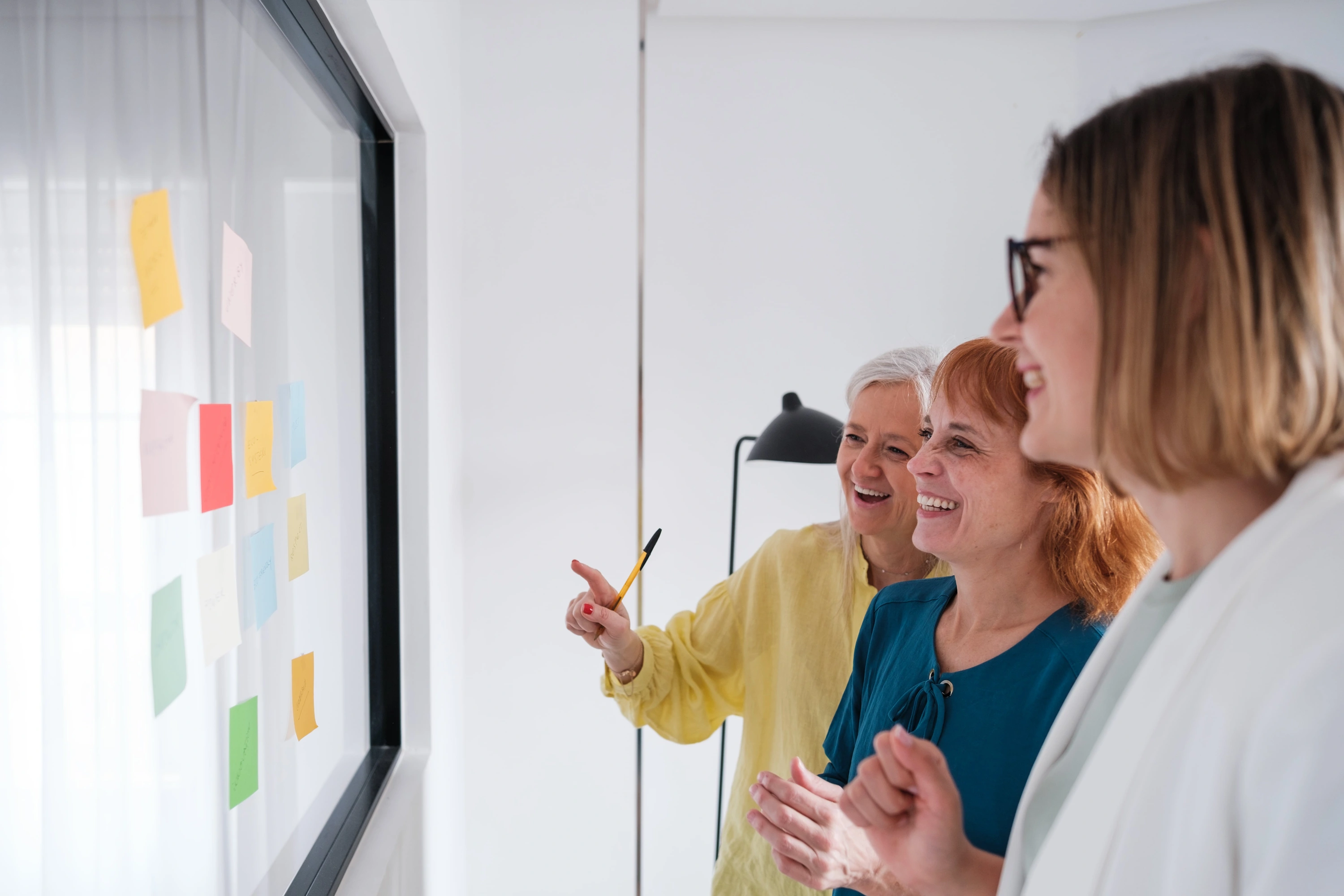 Arts venue team reviewing a planning board together, discussing workflows and operational tasks.