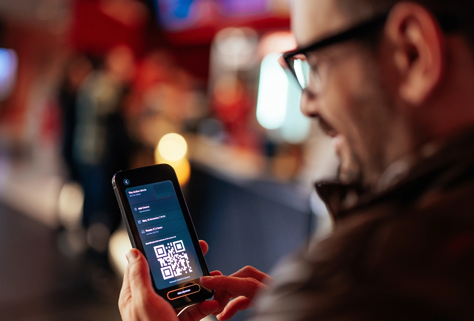 Man gets looks at his ticket on his phone