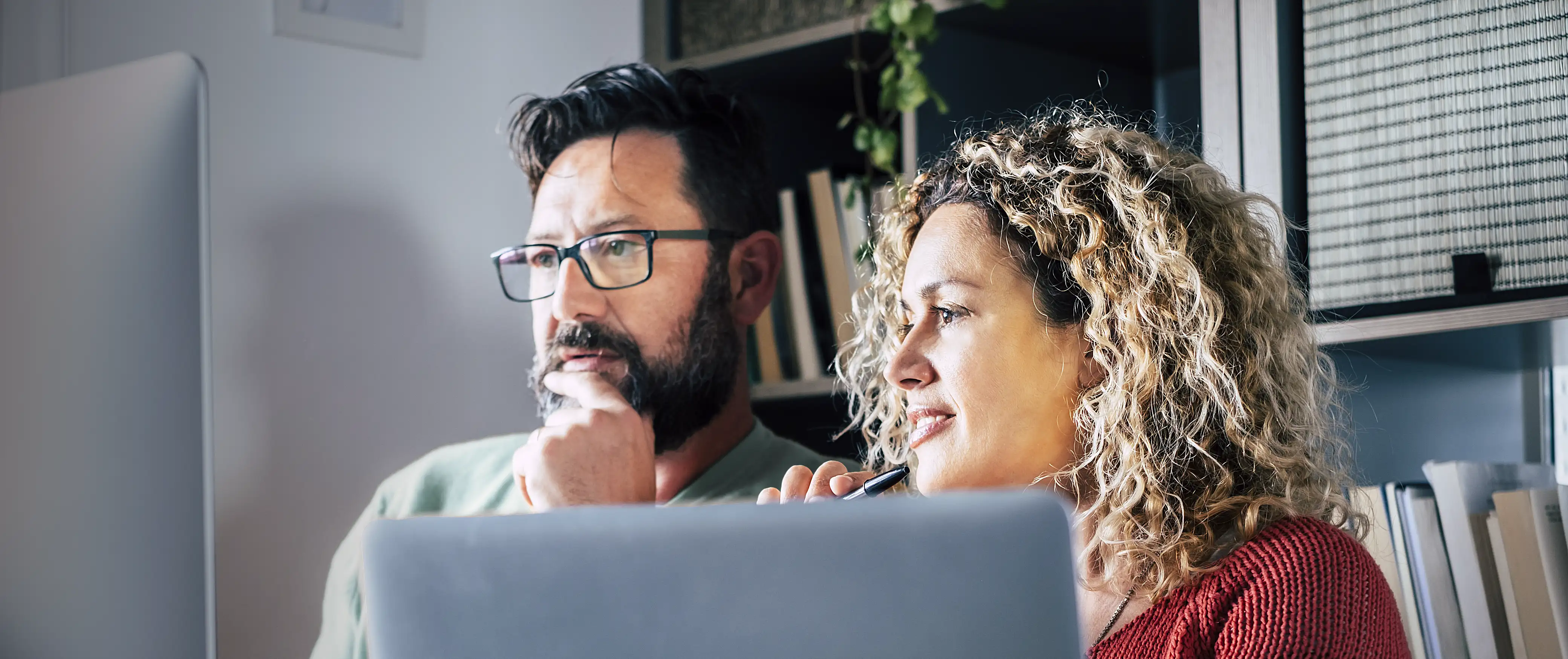 Two people reviewing ticketing software pricing options together.